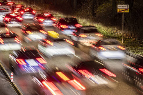 Deutschland, Baden-Württemberg, Stuttgart, Unscharfe Bewegung eines Staus auf einer mehrspurigen Autobahn bei Nacht - WDF07284