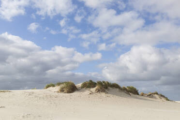 Germany, Schleswig-Holstein, St. Peter-Ording, Clouds floating over sand dune - ASCF01742