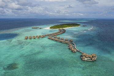 Aerial view of a luxury resort with bungalow on a small island in the Laccadive Sea, Indian Ocean, Maldives archipelagos. - AAEF17522