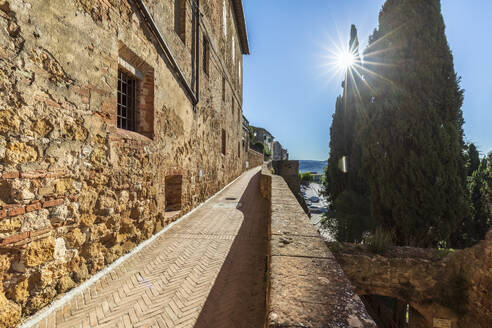 Italien, Toskana, Pienza, Sonne scheint über leerem Fußweg in historischer Stadt - FOF13611