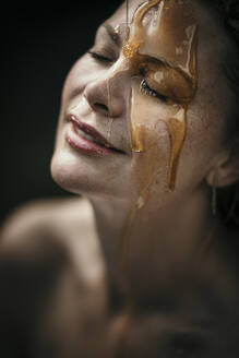 Woman with liquid on face at health spa - MJRF00925