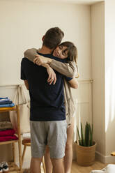 Woman hugging man at home - EBSF03004