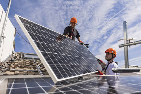 Engineers together installing solar panels - JCCMF10076