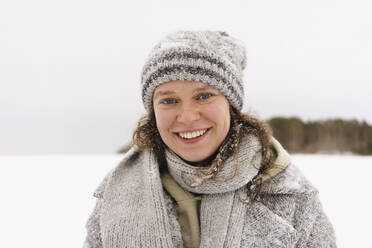 Happy woman wearing knit hat in winter - SEAF01870