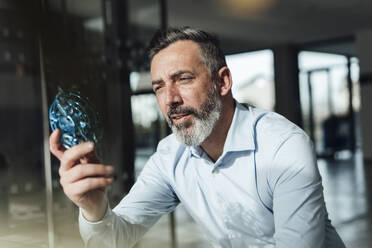 Mature businessman examining electric computer fan - JOSEF18012