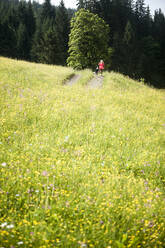 Woman running with dog on sunny day - HHF05833