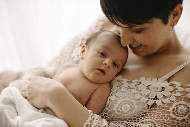 Mother embracing newborn baby boy - GMLF01345