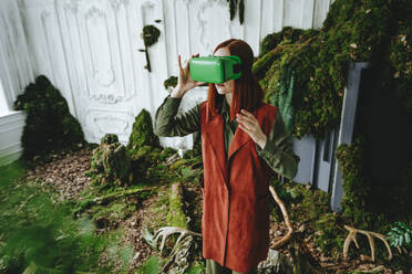 Redhead woman wearing virtual reality simulator - YTF00675
