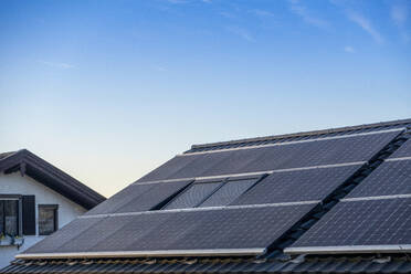 Germany, Bavaria, House roof covered in solar panels - MAMF02741