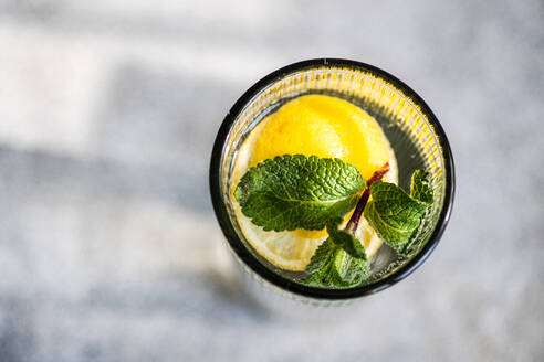 Mojito cocktail with mint and lemon served in the crystal glass on concrete table - ADSF43551