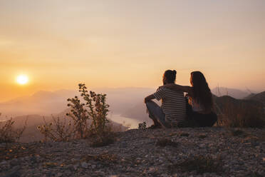 Couple sitting and enjoying sunset - PCLF00320