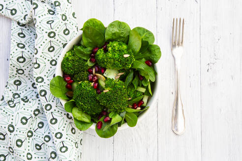 Bowl of green salad with broccoli, corn salad, cashews, cucumber and various seeds - LVF09302