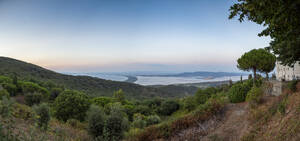 Italy, Tuscany, Monte Argentario, Panoramic view from Monte Argentario peninsula at dusk - MAMF02746