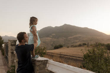 Girl with father enjoying sunset - VIVF00475