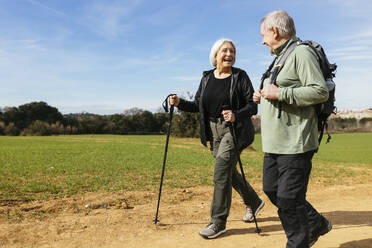 Happy senior couple hiking together in nature - EBSF03067