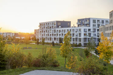 Germany, Bavaria, Munich, Modern suburb at sunset - MAMF02758