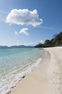 Scenic view of beach under cloudy sky - PNAF05165