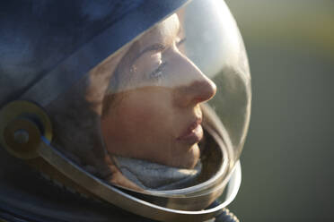 Thoughtful mature woman wearing space helmet - AZF00501