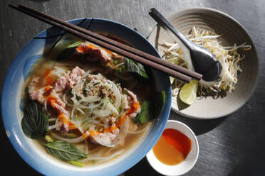 Bowl of Vietnamese traditional pho chicken noodle soup in a street restaurant, Tan Chau, Vietnam, Indochina, Southeast Asia, Asia - RHPLF23717