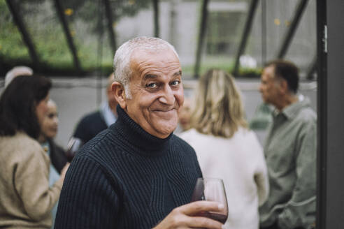 Portrait of happy mature man wearing sweater at dinner party - MASF36258