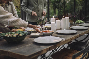 Hand of senior woman preparing dining table for party - MASF36263