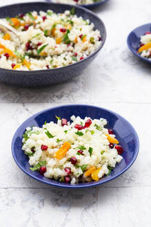 Bowls of cauliflower salad with pomegranate seeds, pistachios, mint, parsley and dried apricot - LVF09319