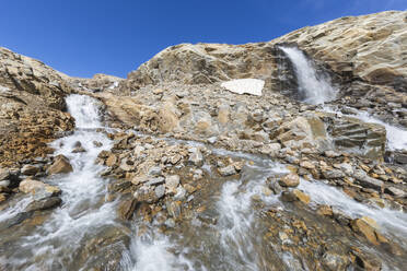 Idyllic waterfall amidst rocks below blue sky, Carinthia, Austria - FOF13688