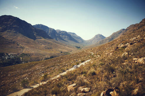 Car moving on road amidst Cederberg Mountains on sunny day - KOF00052