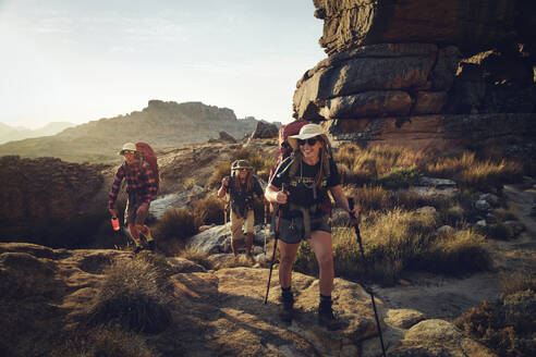 Happy woman hiking with friends on Cederberg Mountain - KOF00059