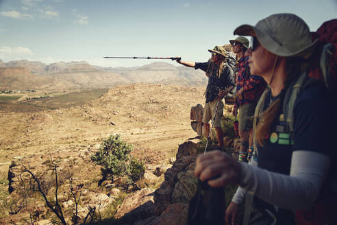 Hiker assisting friends standing on Cederberg Mountains - KOF00062