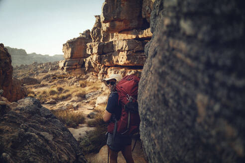 Smiling woman with backpack hiking on Cederberg Mountains - KOF00064