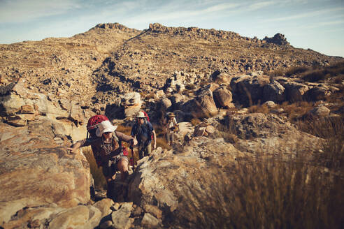 Hiker friends trekking together at Cederberg Mountains on sunny day - KOF00069
