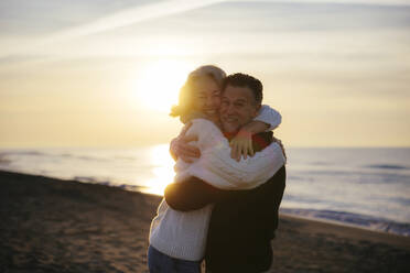 Smiling mature man and woman hugging each other - EBSF03153