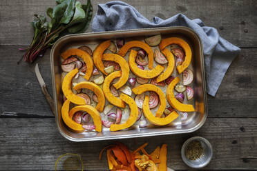 Sliced onions, pumpkins and common beets on baking sheet - EVGF04320