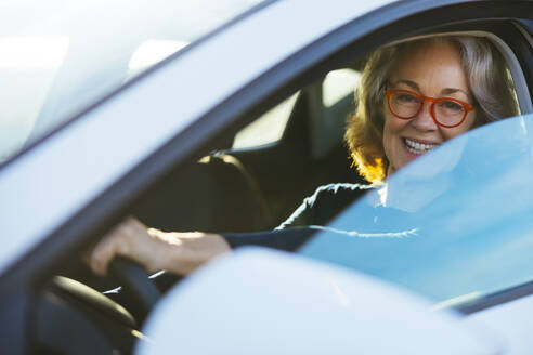 Happy mature woman driving car - EBSF03183