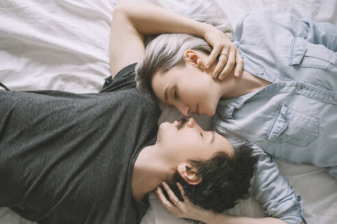 Man and woman lying on bed and embracing each other - NDEF00553