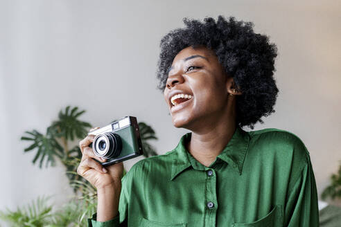 Cheerful young woman with retro style camera - AAZF00362