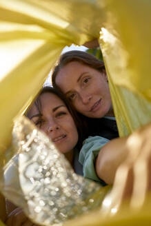 Activist women looking in yellow plastic bag - ANNF00119