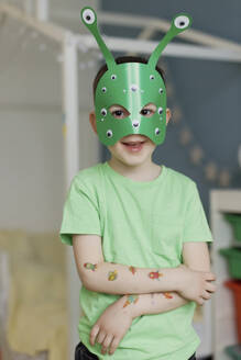 Junge mit Aufklebern auf der Hand und grüner Alien-Maske - ONAF00504