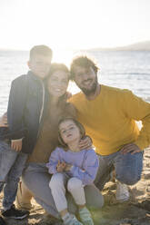 Happy family spending leisure time at beach on sunny day - JOSEF18542