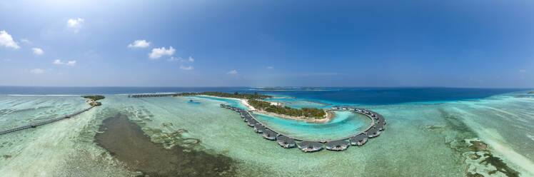 Water bungalows on Kanuhura Island under blue sky in Maldives - AMF09882