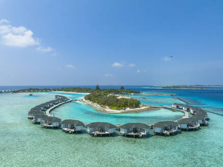 Water bungalows on Kanuhura Island under blue sky - AMF09883