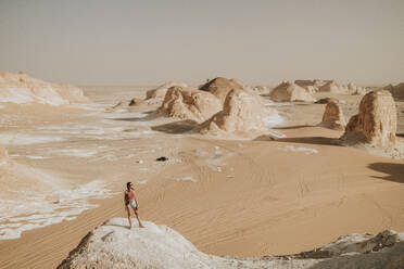 Woman standing on rock and enjoying vacations - GMLF01449