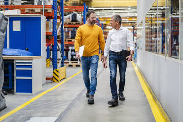 Businessmen walking together in factory - DIGF19902