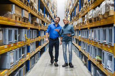 Businessman and manager monitoring merchandise in warehouse - DIGF19948