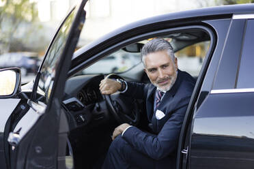 Smiling businessman sitting in car - JJF00776