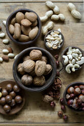 Studio shot of various nuts lying on wooden tray - ASF06858