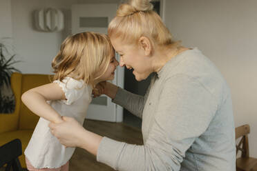 Grandmother playing with granddaughter at home - VIVF00590