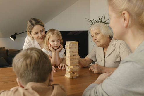 Great grandmother playing game with family at home - VIVF00622