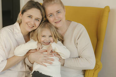 Woman with mother holding granddaughter at home - VIVF00643